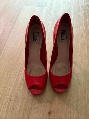 Signature Red Patent Peep Toe Pumps